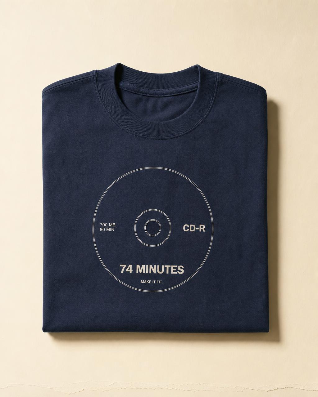 Folded navy t-shirt printed with a minimal CD-R disc and the words 74 Minutes